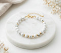 Pulseira Eira dourada Howlite branca A
